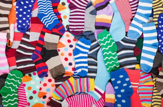 Different multicolored bright socks. Abstract background image.